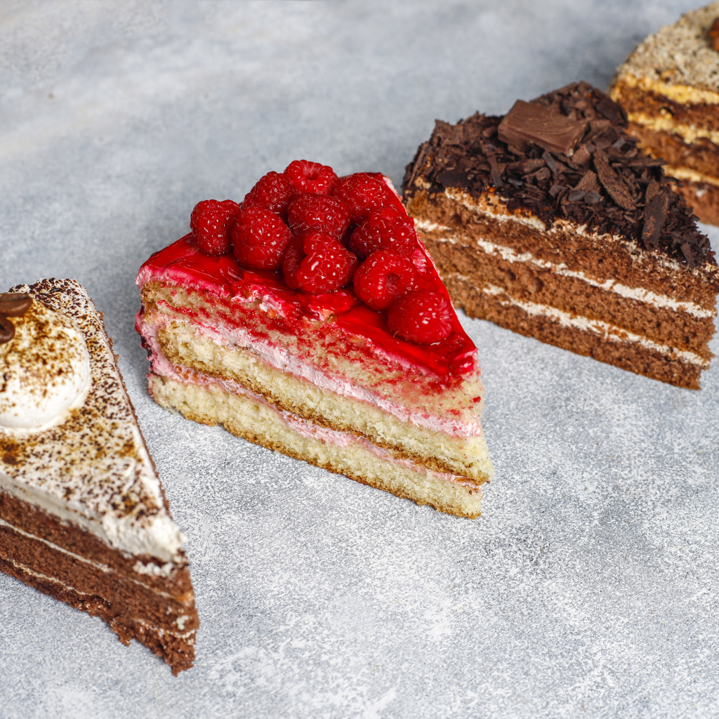 Четыре разных вкусных куска торта на столе