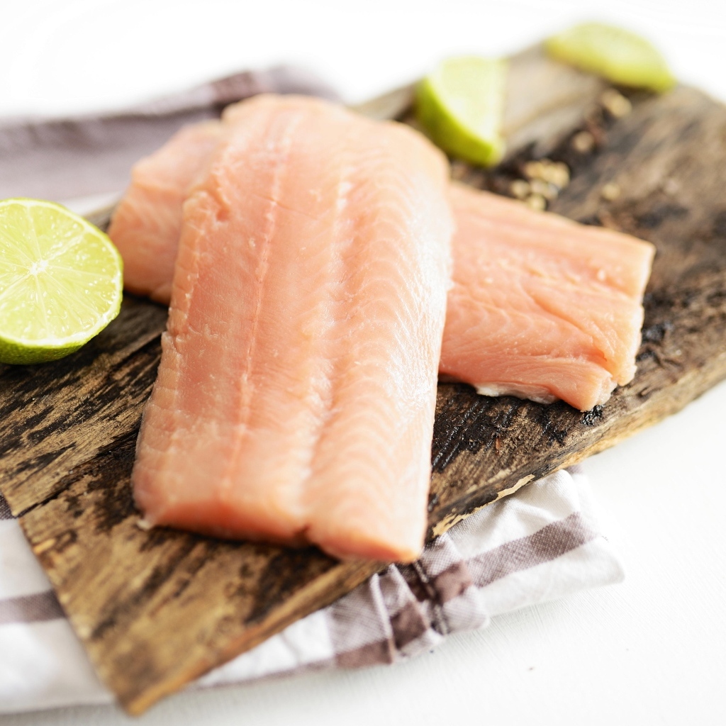 Кусочки рыбы на столе с лаймом