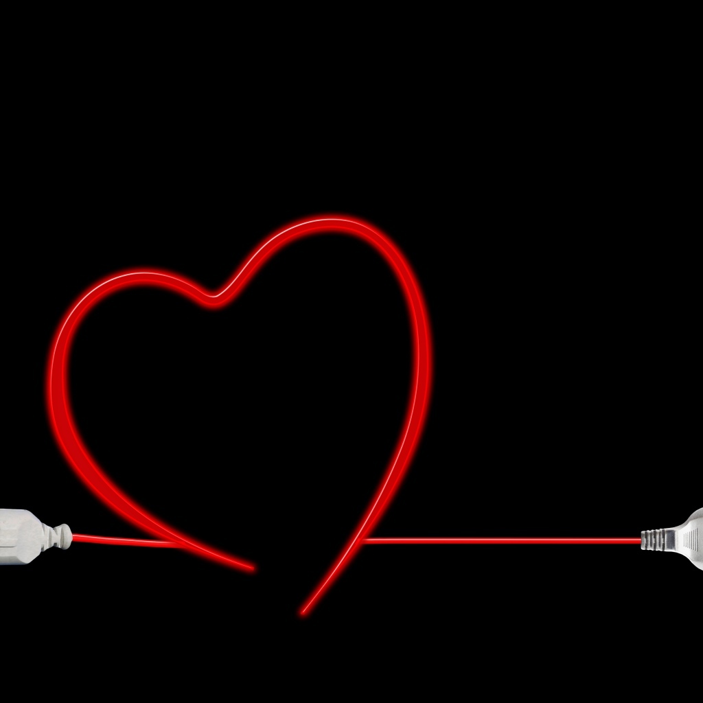 Красное сердце из провода на черном фоне