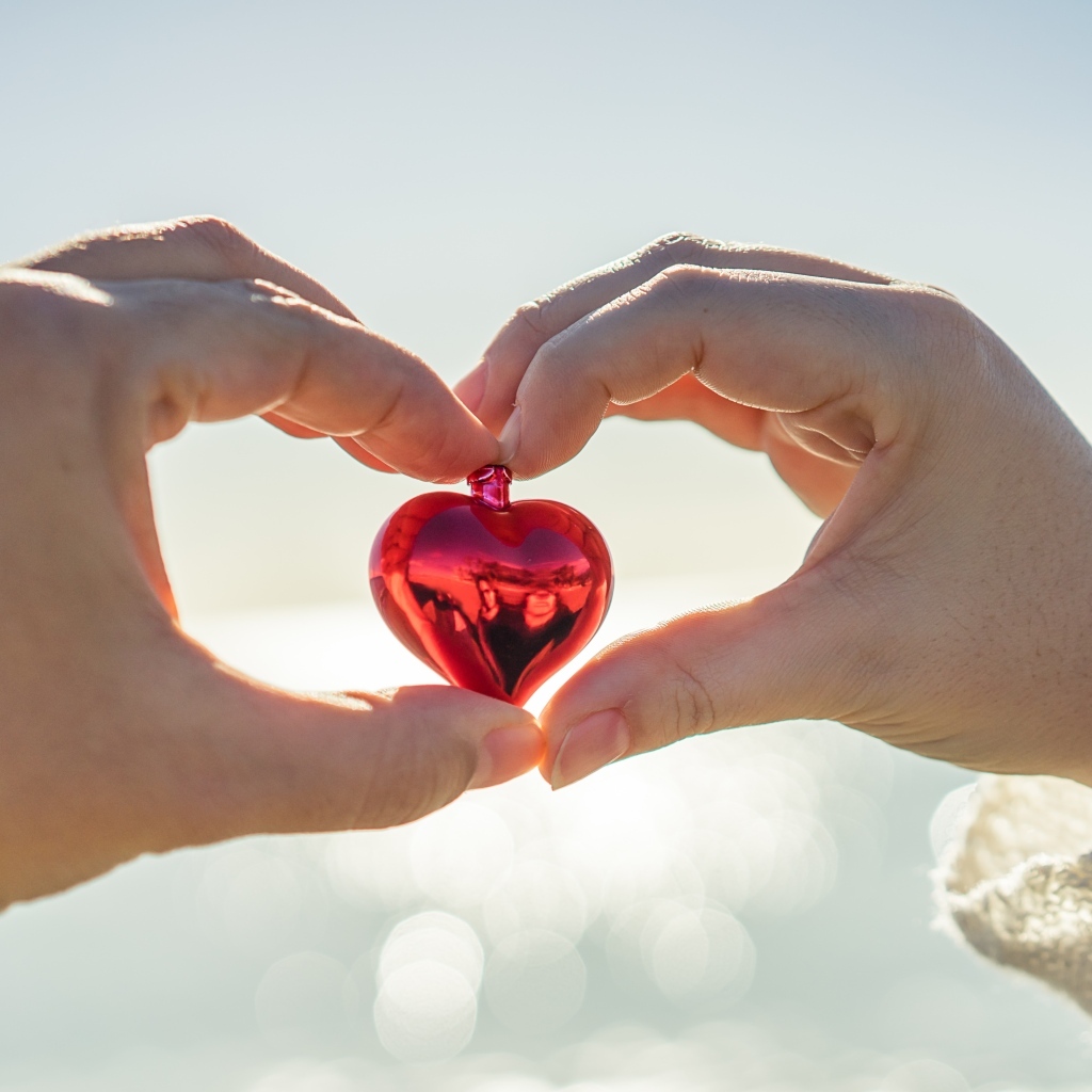 Маленькое сердечко в руках влюбленной пары