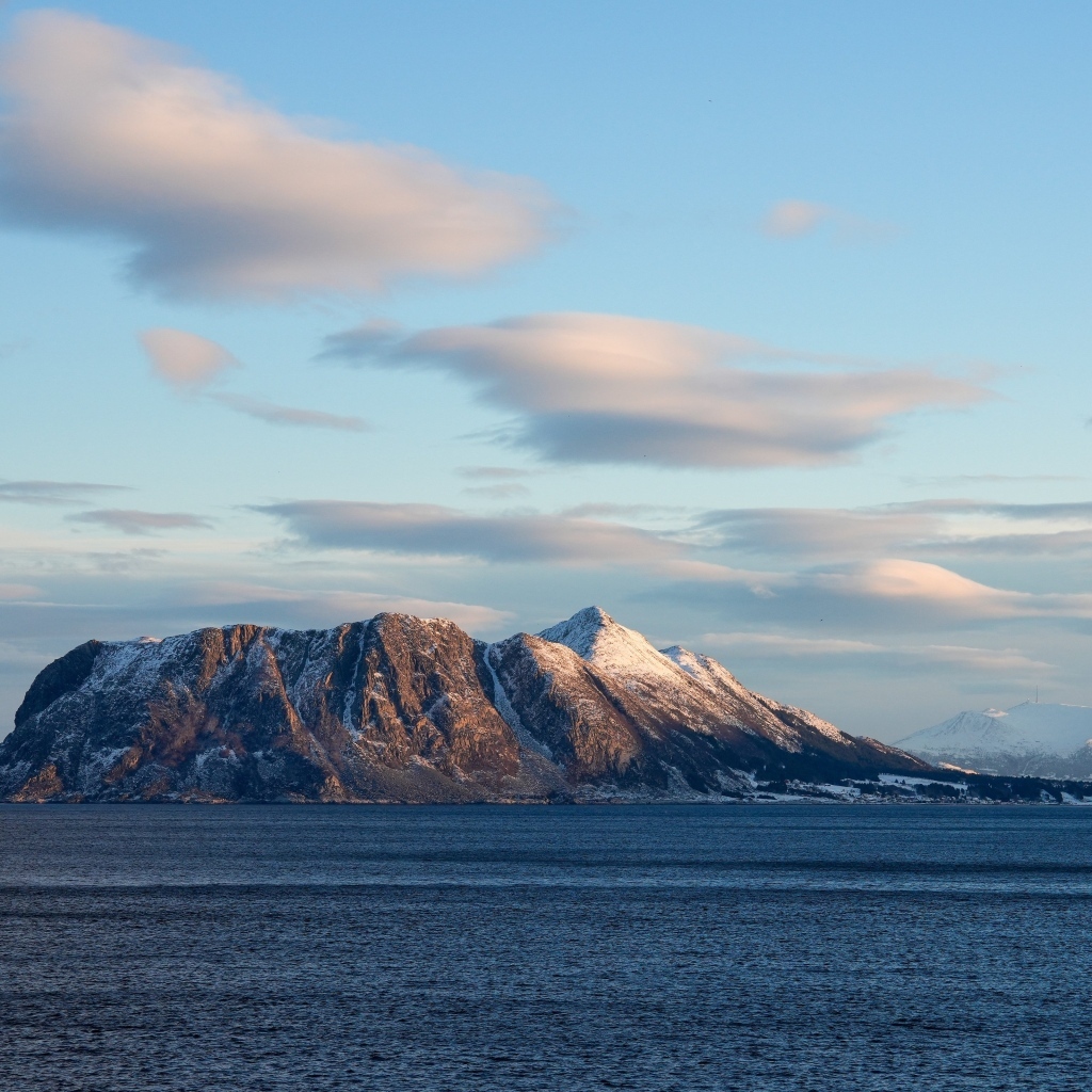 Скала в лучах солнца в море