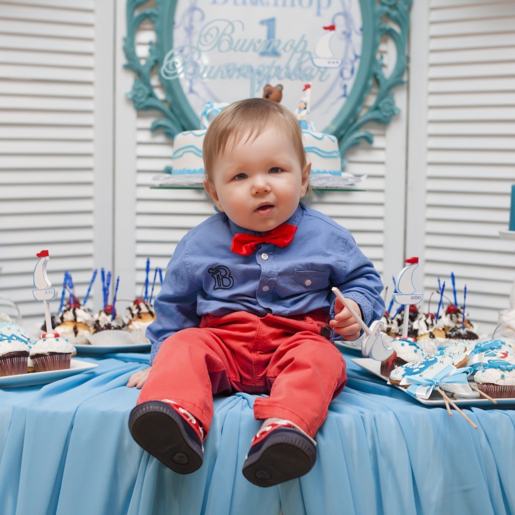 Маленький ребенок с угощениями на день рождения