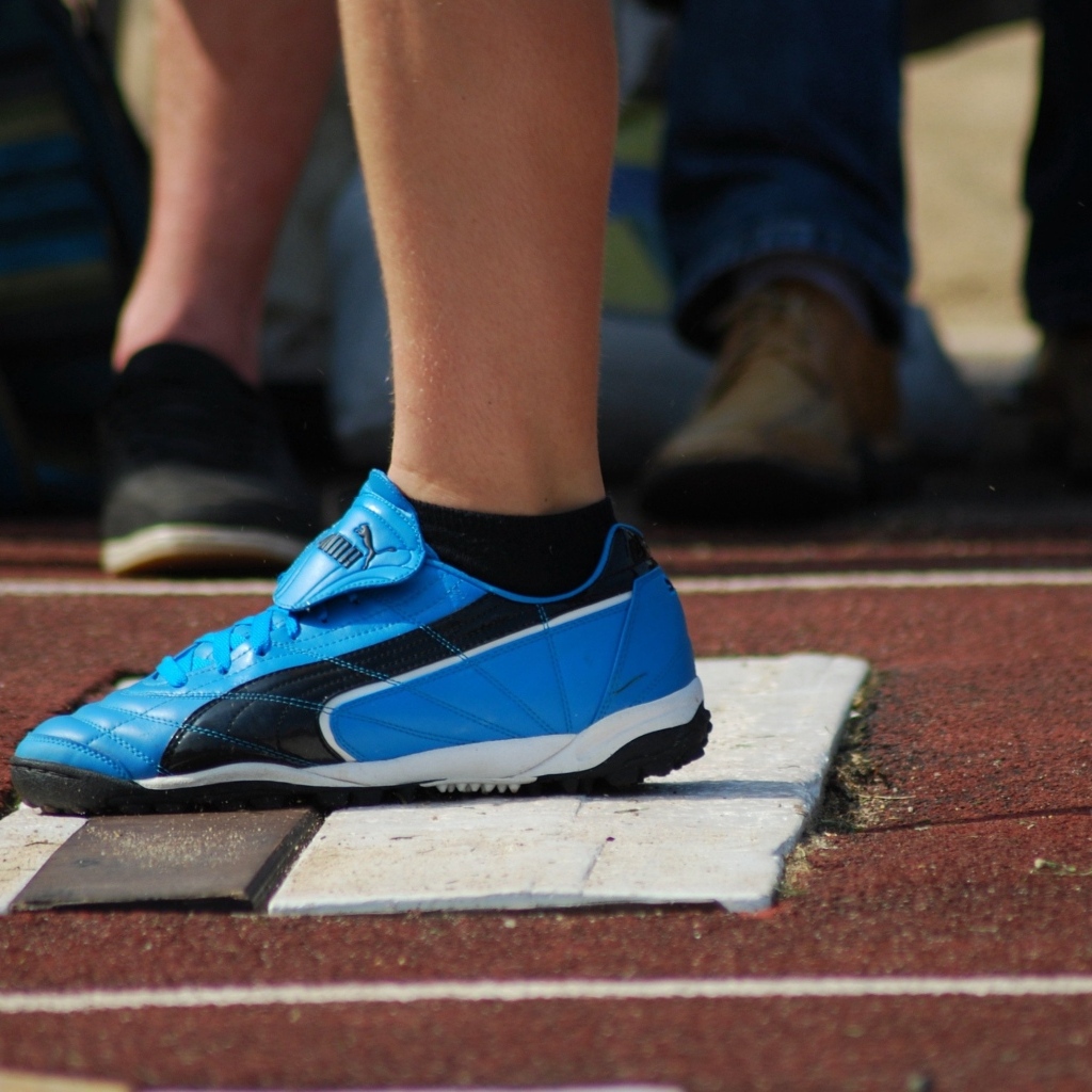 Голубые кеды на ноге спортсмена