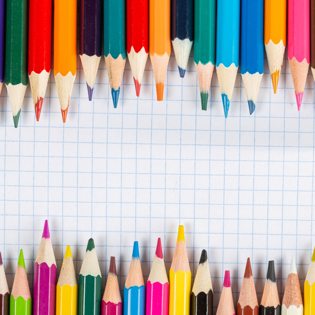 Заточенные карандаши на листе бумаги в клеточку