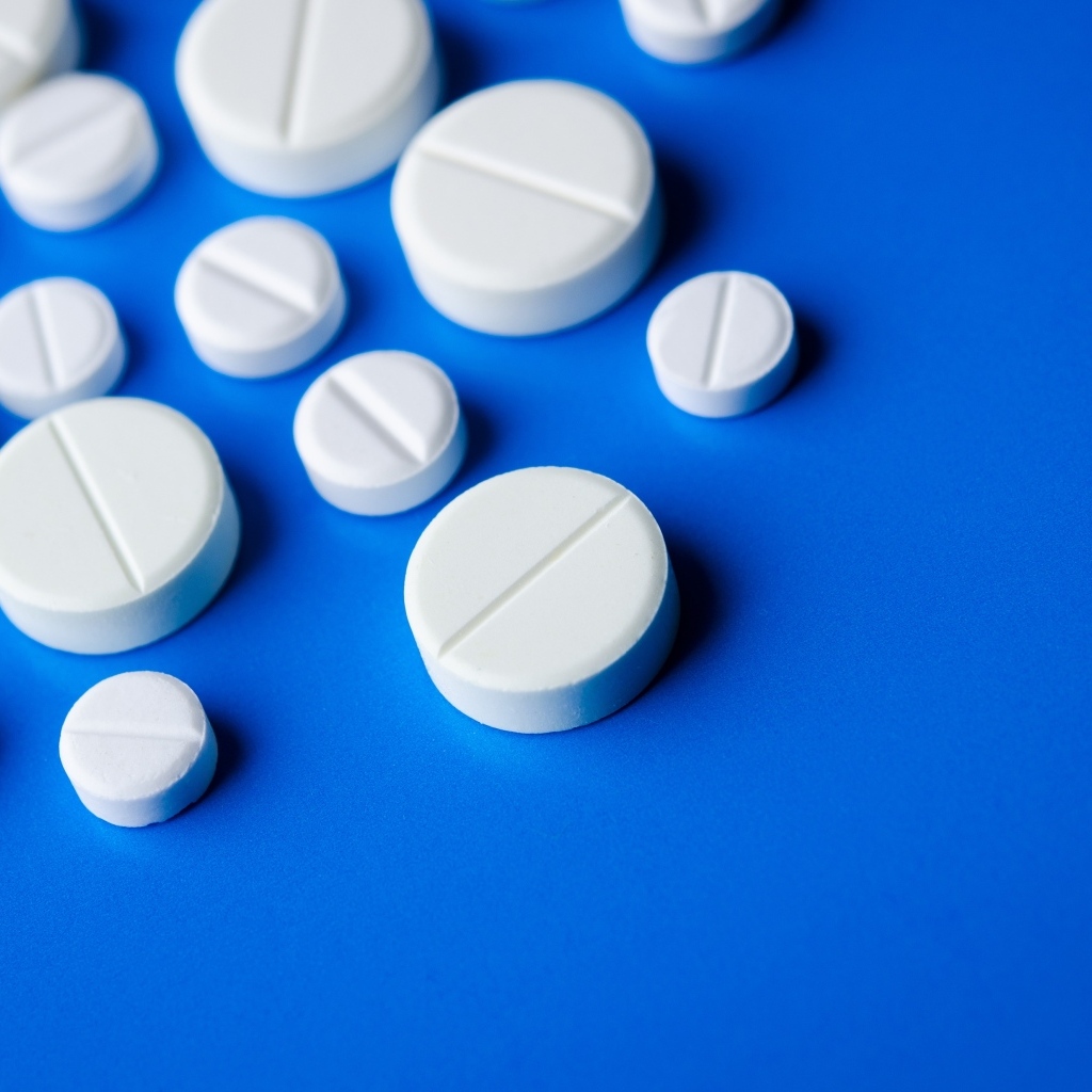 Белые таблетки на синем фоне