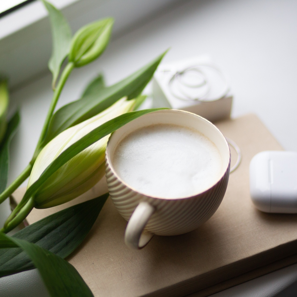 Чашка кофе на подоконнике с цветами лилии 