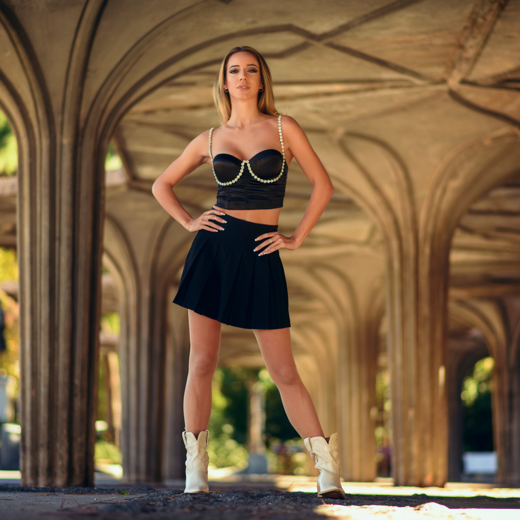 Красивая девушка в черном наряде позирует для фото 