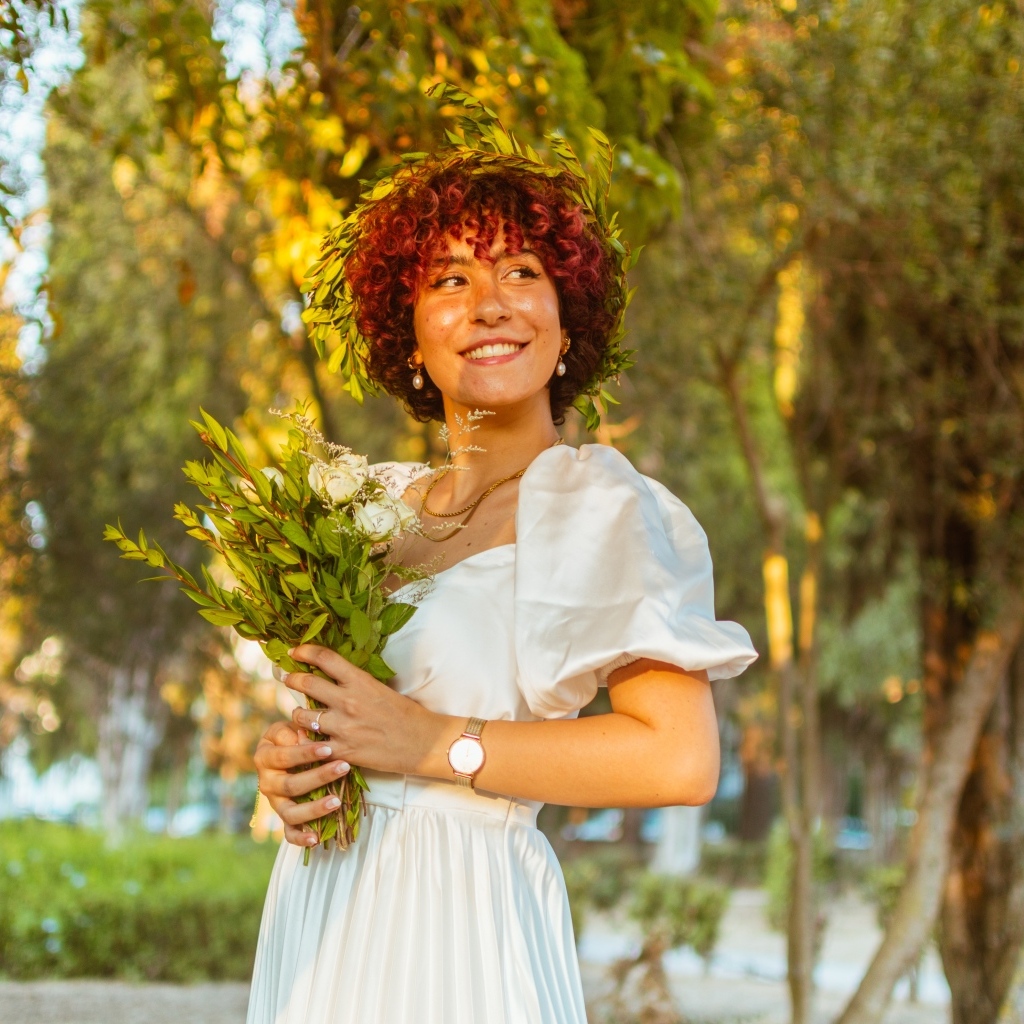 Красивая улыбающаяся рыжеволосая девушка с букетом