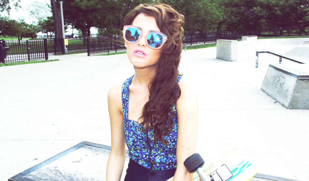 A girl with glasses and a skateboard, swag
