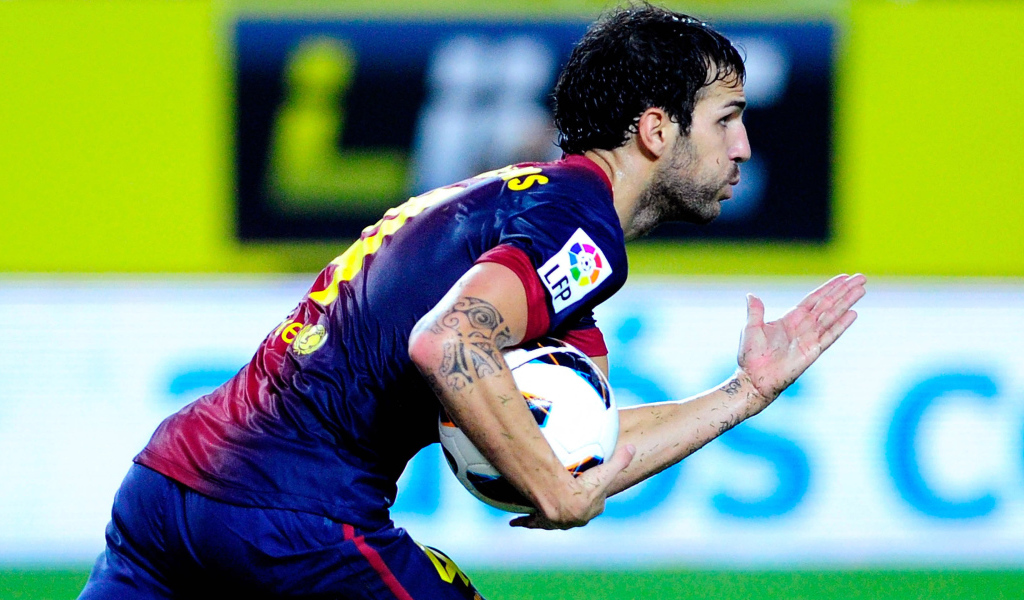 The player of Barcelona Francesc Fabregas runs with a ball