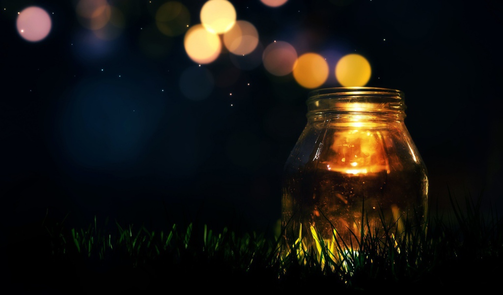 Стеклянная банка на траве ночью