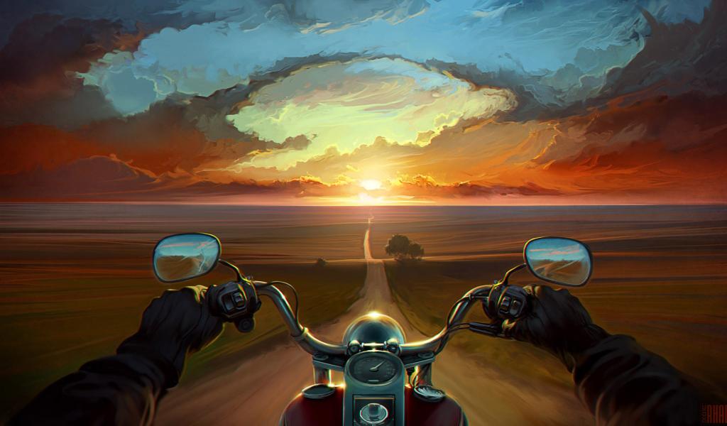 Мотоциклист едет на закат