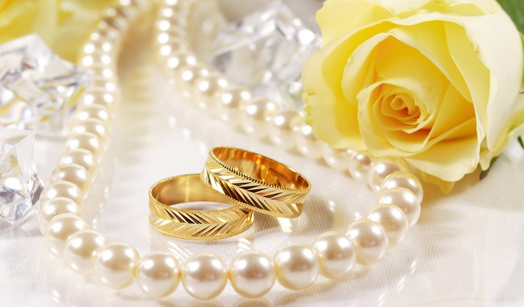 Свадебные кольца и жёлтая роза