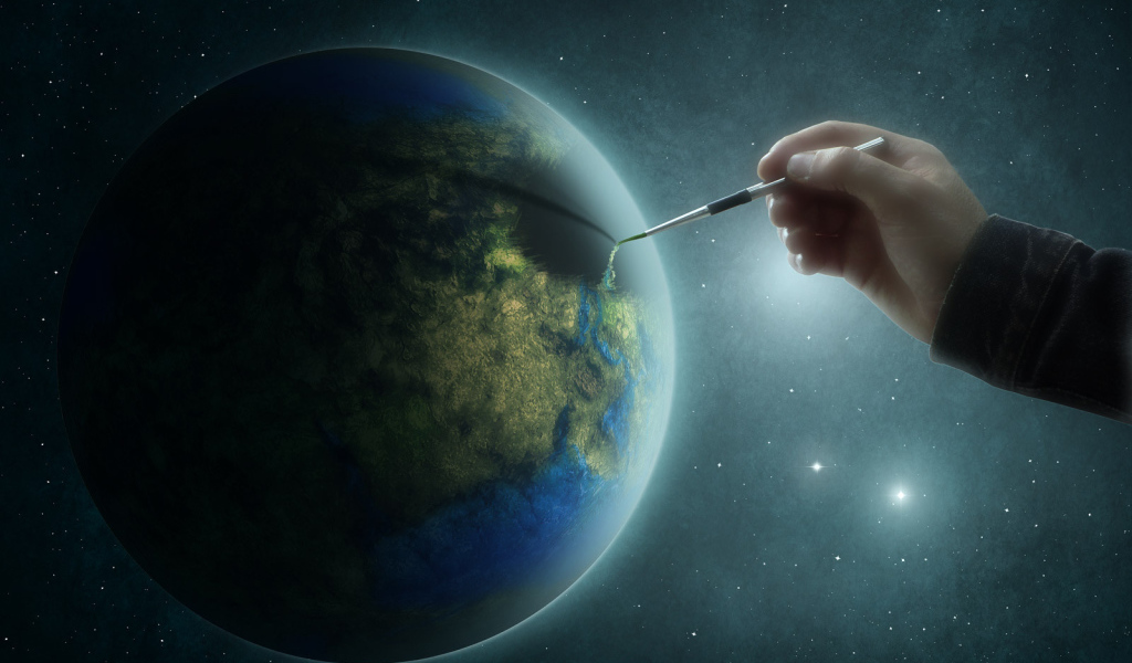 Рука рисует на планете