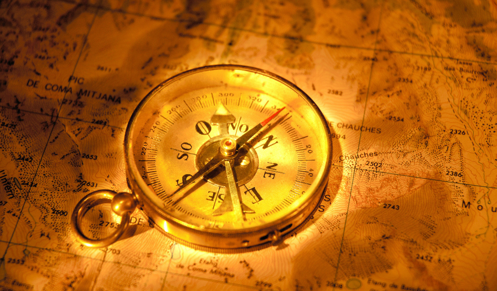Старинный компас на карте путешественника