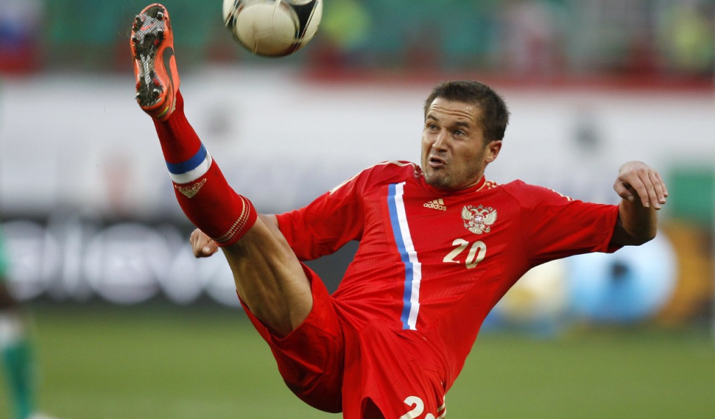 Полузащитник сборной России Виктор Файзулин бьет по мячу