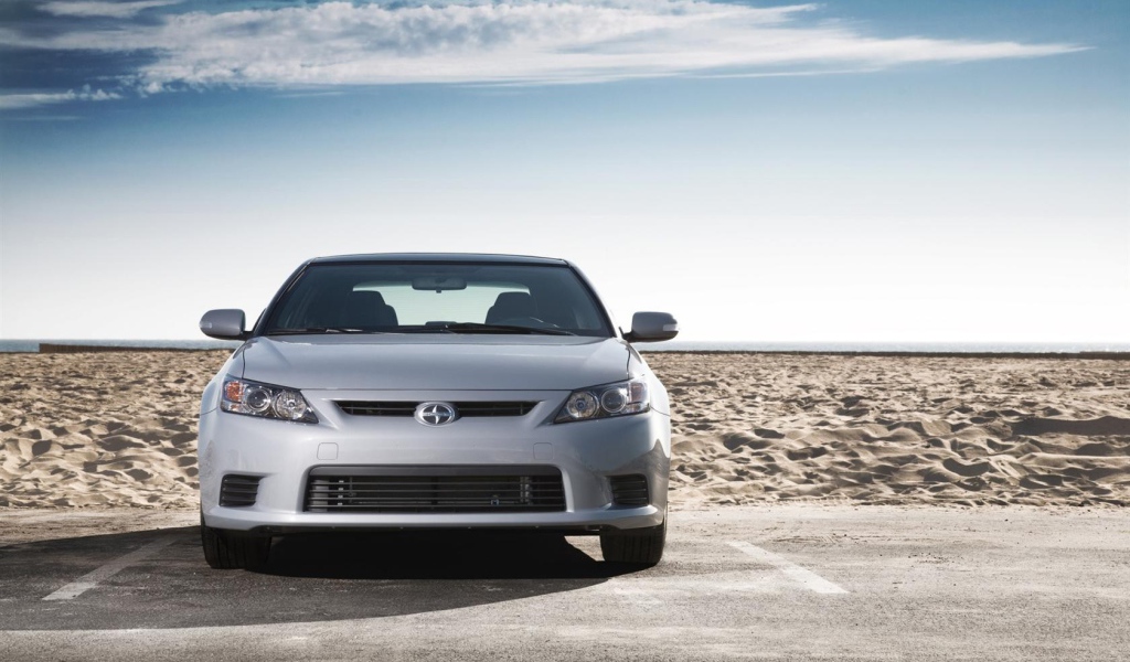 Серый Scion на фоне песка