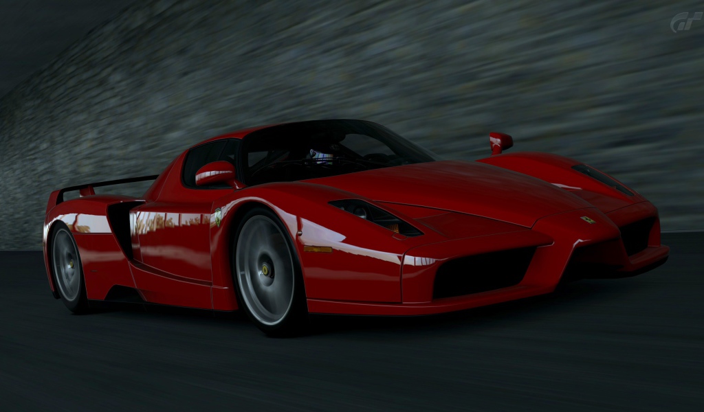 Красный Ferrari Enzo мчится на черном фоне