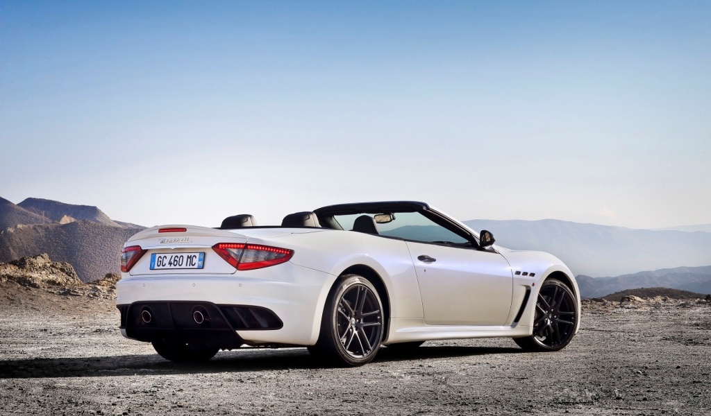 White convertible Maserati mountains in the background
