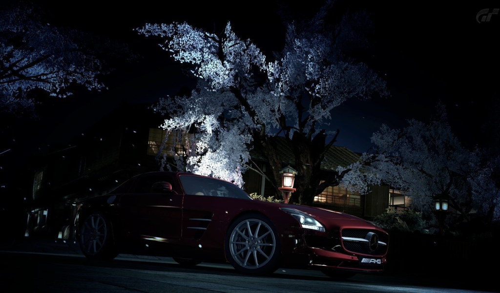 Темно красный Mercedes-Benz на фоне цветущего дерева