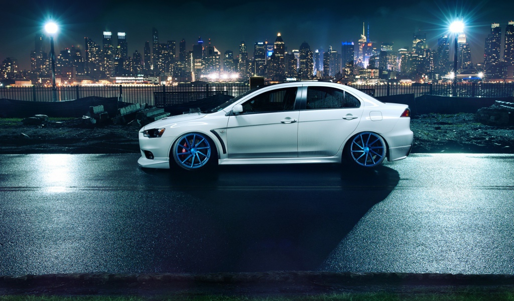 Автомобиль Mitsubishi Lancer Evo X на фоне города