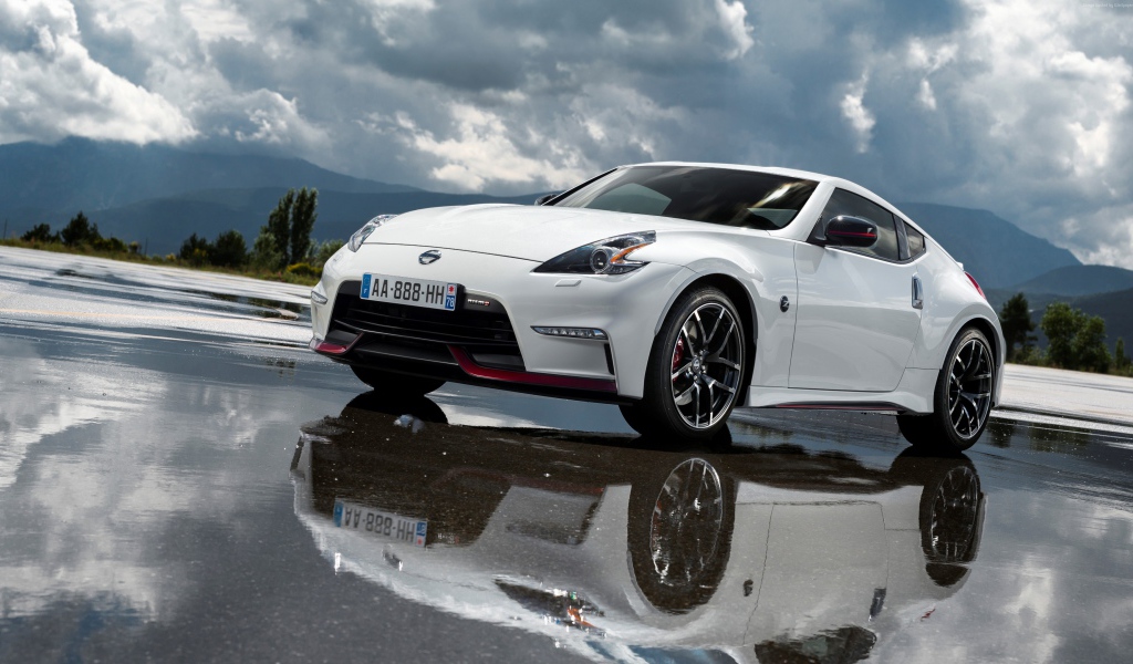 Белый спортивный автомобиль Nissan на мокром асфальте