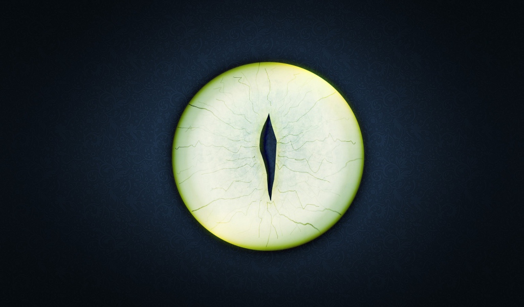 Круглый зеленый глаз на черном фоне