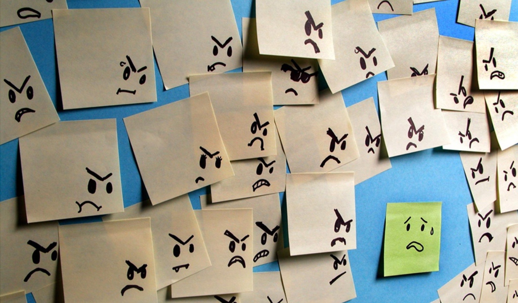 Испуганный стикер в окружении злых стикеров