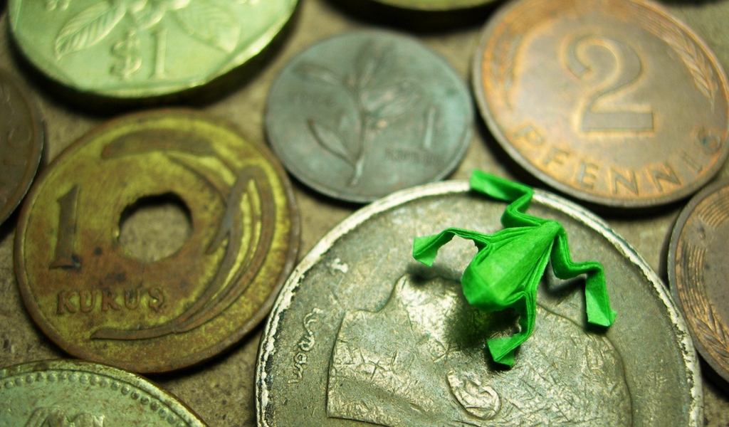 Frog figurine on coins