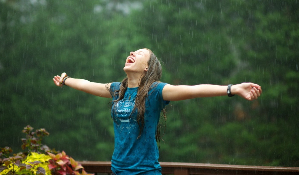 Девушка радуется летнему дождю