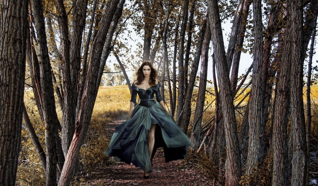 Девушка в черном платье среди деревьев
