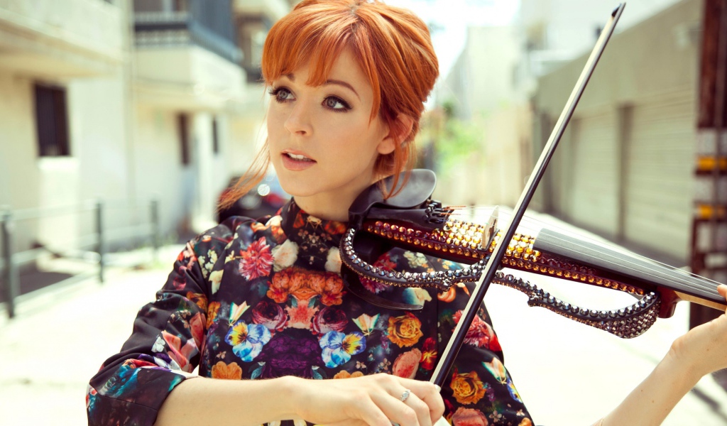 Рыжая девушка играет на скрипке со стразами