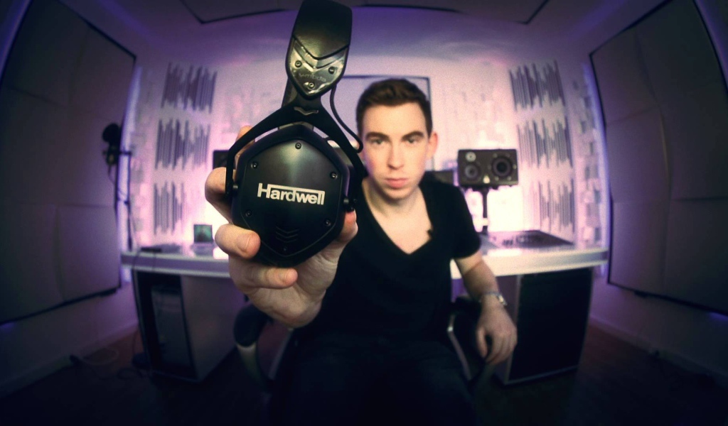 Музыкант держит в руке наушники Hardwell