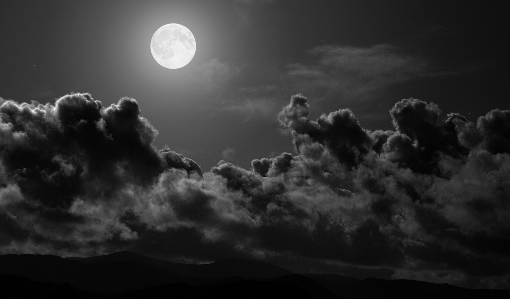 	   The moon over the dark clouds