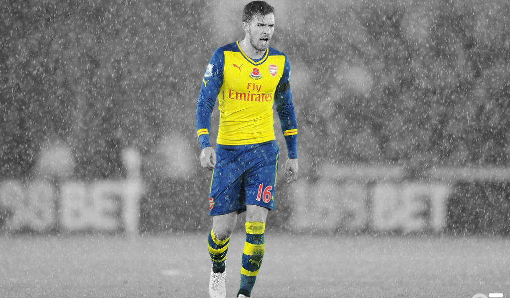 Игрок Арсенала во время дождя, футбол