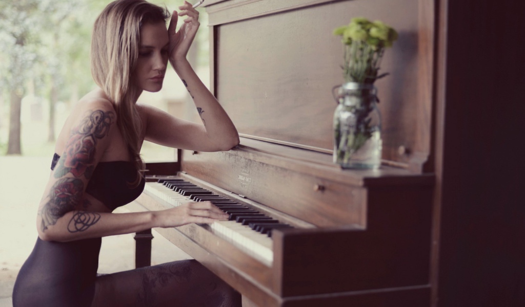 Girl with tattoo playing the piano