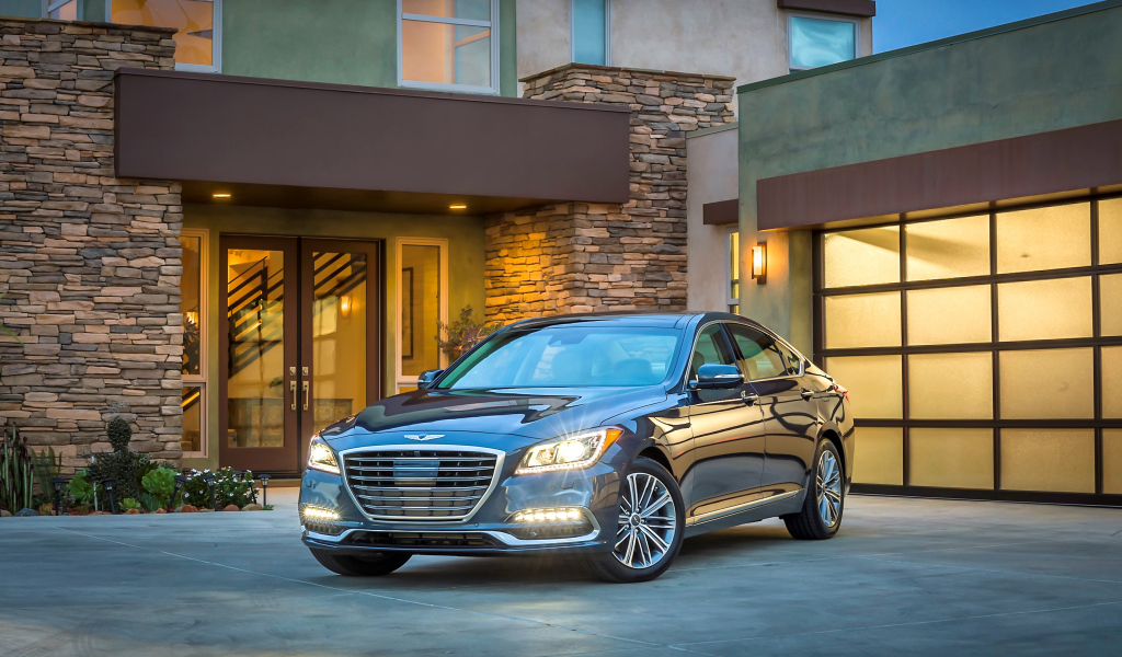 Серебристый автомобиль Genesis G80 с включенными фарами