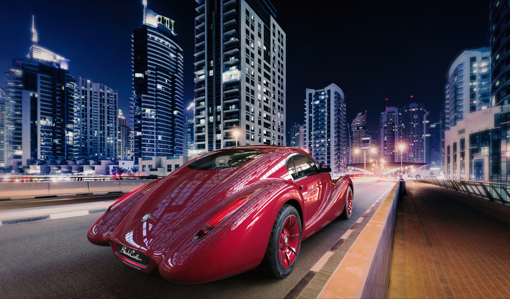 Необычный красный автомобиль Eadon Green Black Cuillin на фоне города 