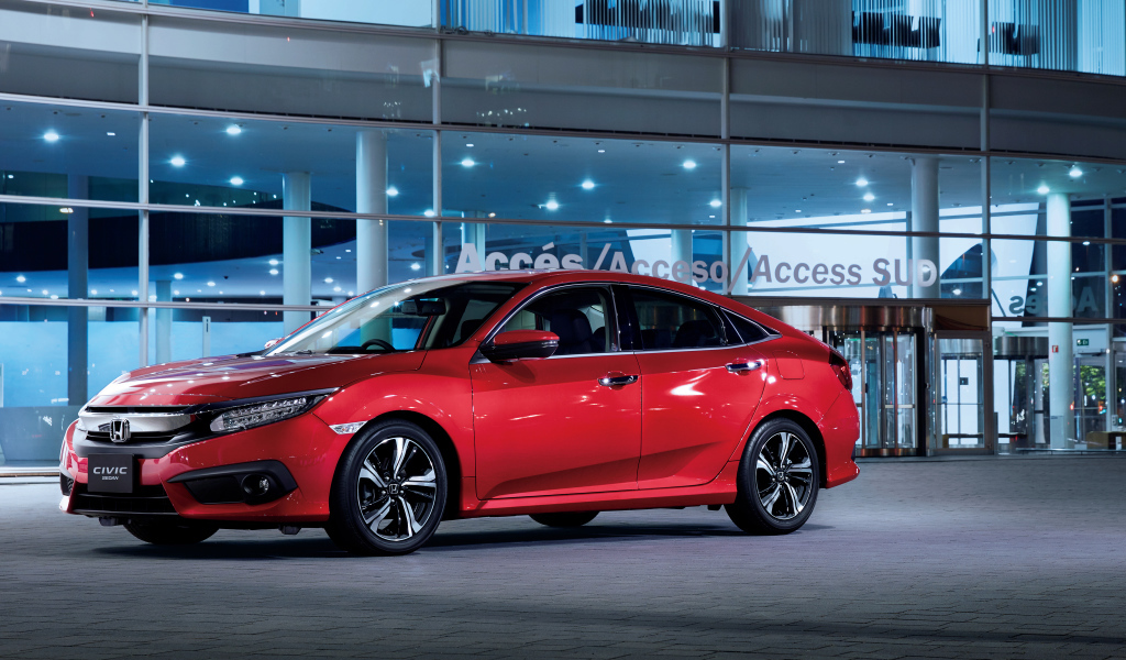 Стильный красный автомобиль Honda Civic в автосалоне