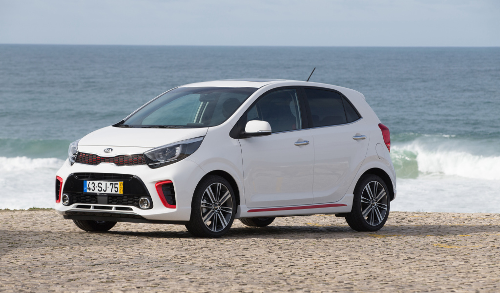 White car KIA Picanto GT Line, 2017 on the background of the ocean