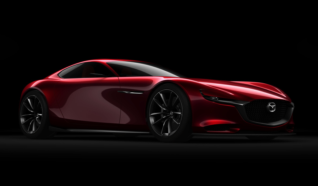 Красный спортивный автомобиль Mazda RX Vision Concept на черном фоне