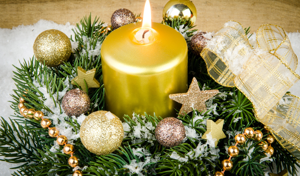 A beautiful burning candle and a wreath at Christmas
