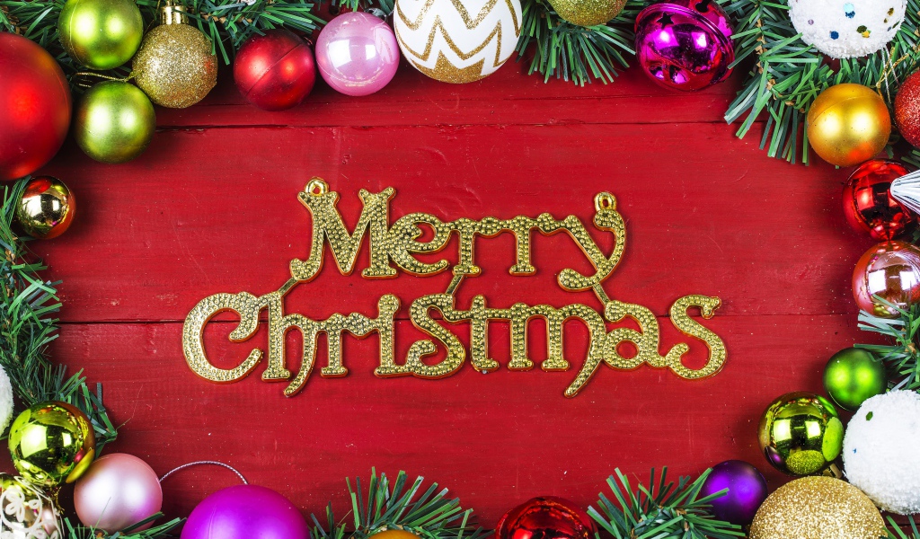 Merry Christmas inscription on a red background with Christmas-tree decorations for Christmas