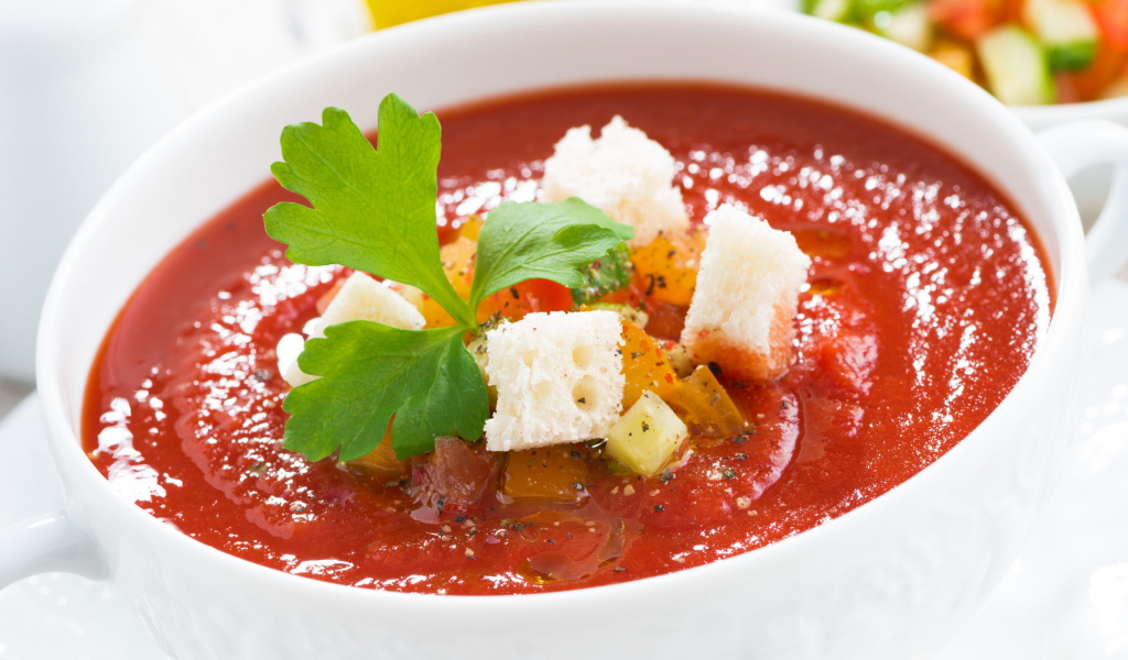 Томатный суп в белой тарелке с гренками 