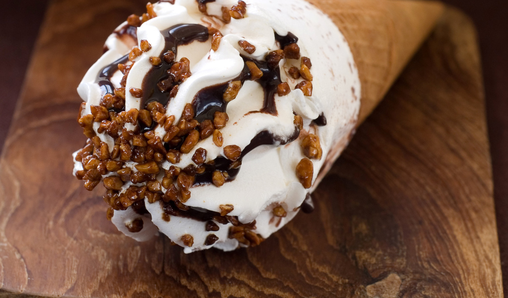 Мороженое рожок с шоколадом на разделочной доске