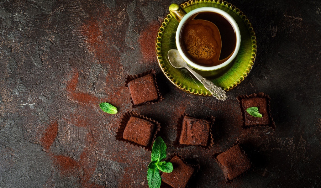 Ароматный кофе в чашке с шоколадными конфетами 