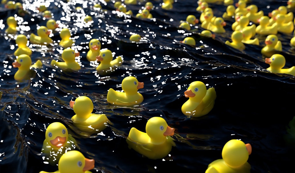 Много желтых резиновых уточек в воде