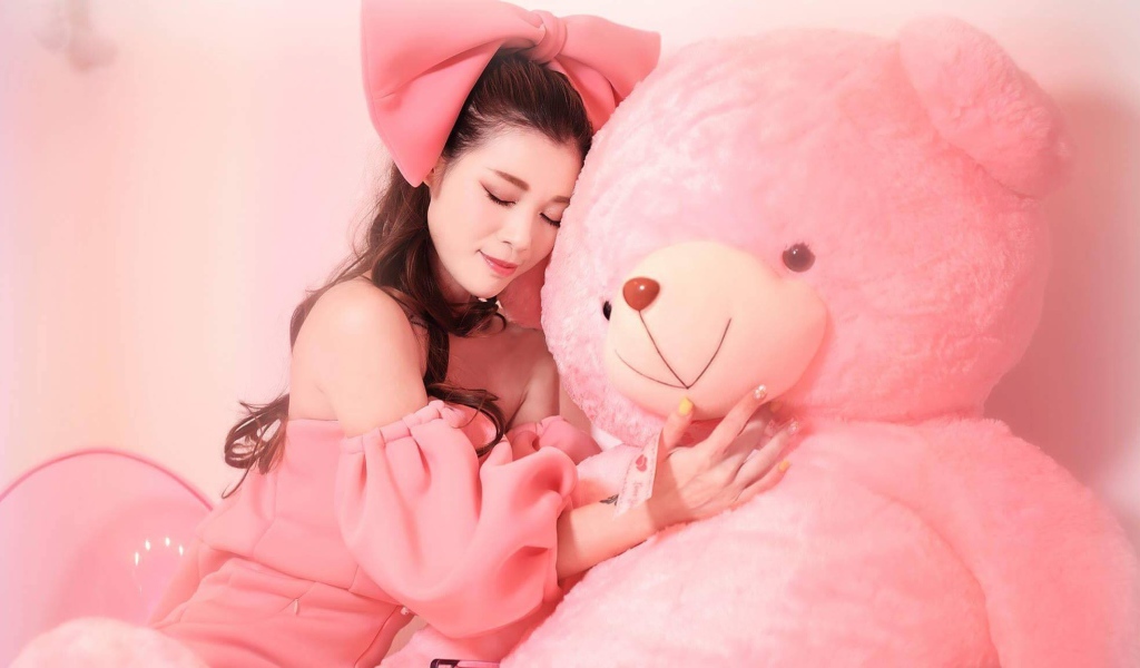 Beautiful Asian girl with a big pink bear