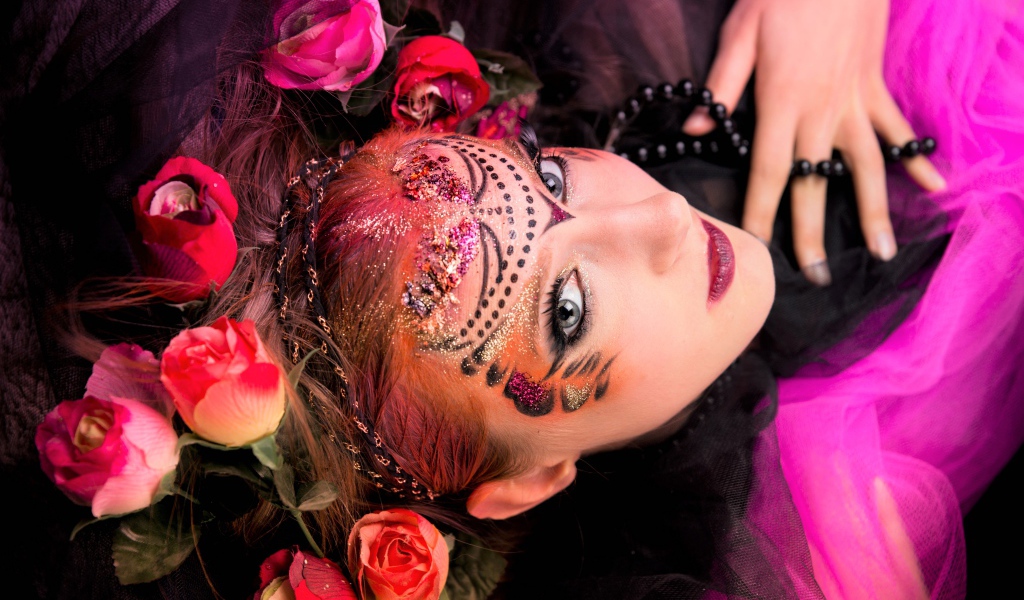 Девушка с блестящим ярким макияжем и розами в волосах
