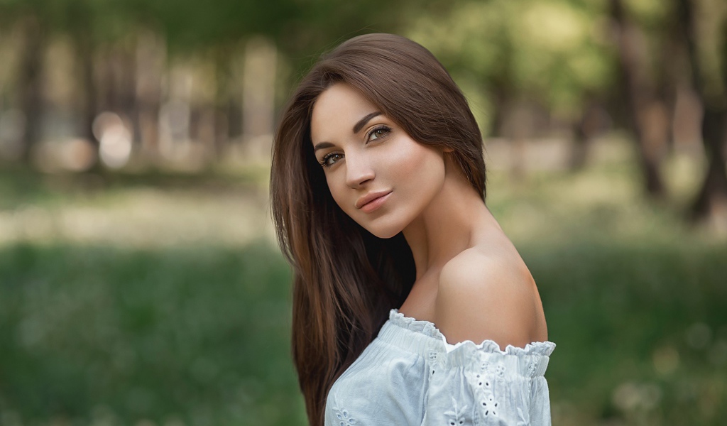 Молодая девушка с длинными волосами в белом 